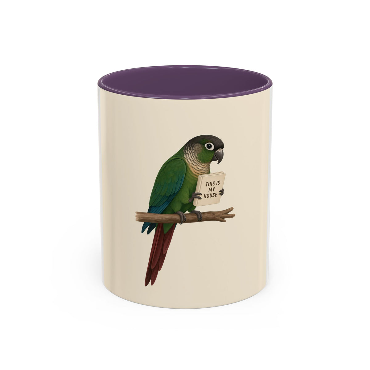 A ceramic mug with a white and cream-colored exterior and a purple interior, featuring a printed illustration of a green parrot perched on a branch holding a sign that reads 'THIS IS MY HOUSE'.
