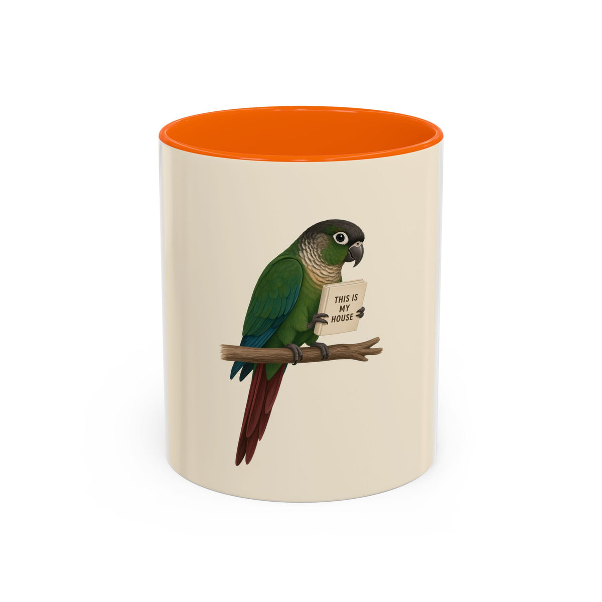 A ceramic mug with a white and cream-colored exterior and a orange interior, featuring a printed illustration of a green parrot perched on a branch holding a sign that reads 'THIS IS MY HOUSE'.