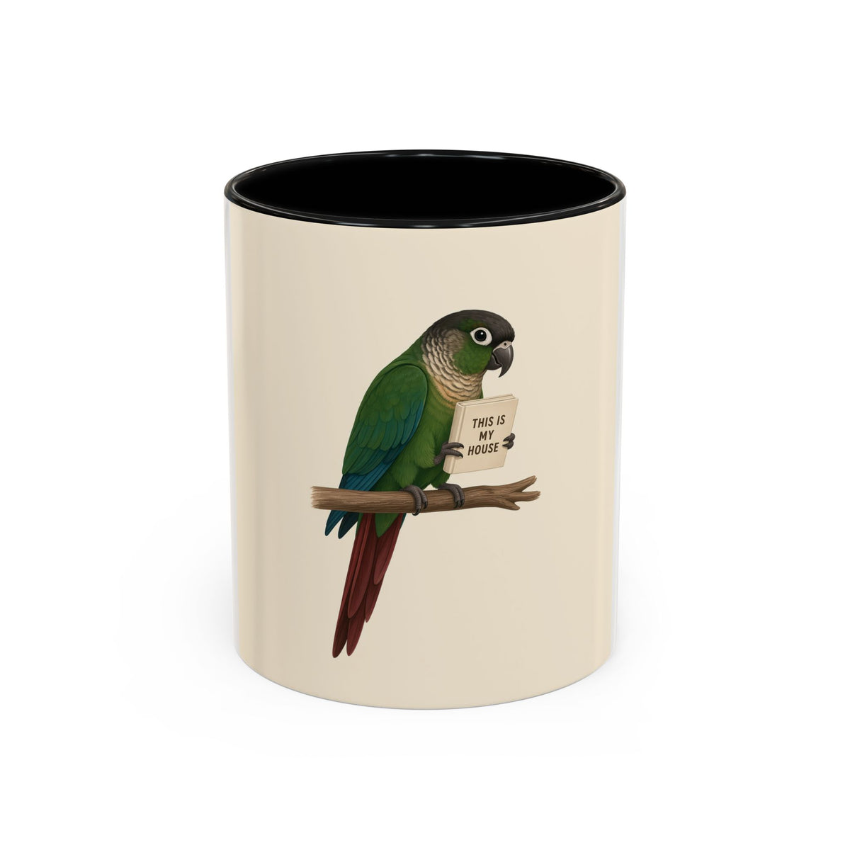 A ceramic mug with a white and cream-colored exterior and a black interior, featuring a printed illustration of a green parrot perched on a branch holding a sign that reads 'THIS IS MY HOUSE'.