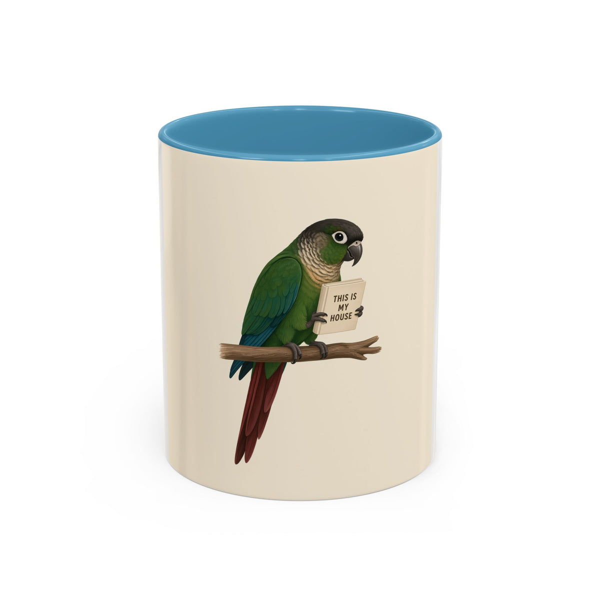 A ceramic mug with a white and cream-colored exterior and a Lt. Blue interior, featuring a printed illustration of a green parrot perched on a branch holding a sign that reads 'THIS IS MY HOUSE'.